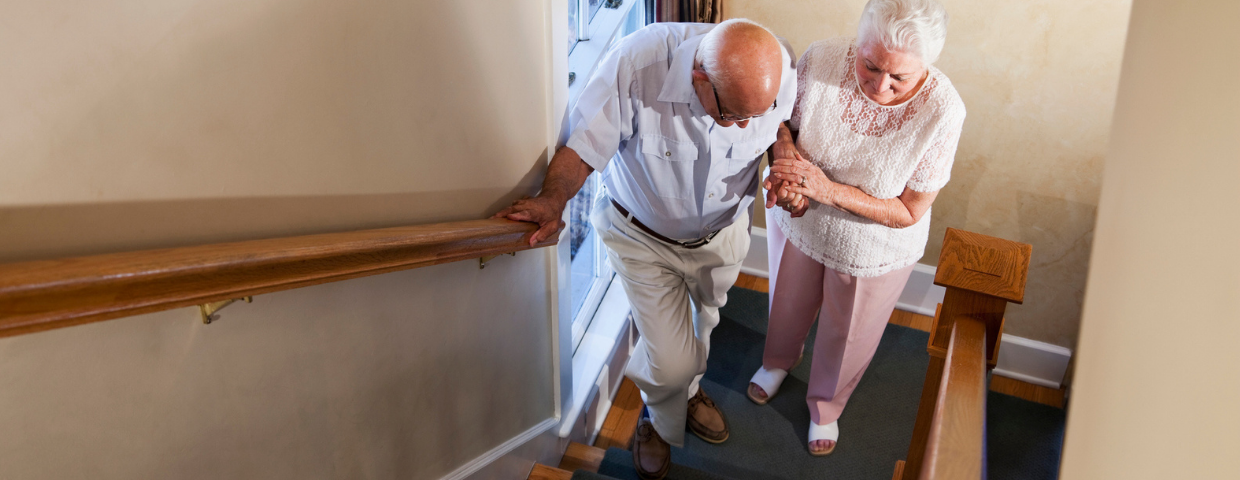 Elderly couple going up the stairs